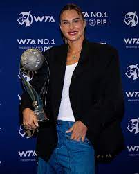 Belarus' Aryna Sabalenka (middle) flanks her trophy she received from the Women's Tennis Association (WTA) on Monday. Sabalenka wins WTA Player of the Year award