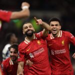 Liverpool forward Mohamed Salah (center) raises a finger in his left hand to celebrate a goal on Sunday. Salah helps Reds thump Spurs, records EPL Christmas record