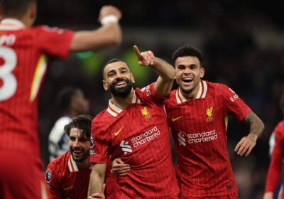 Liverpool forward Mohamed Salah (center) raises a finger in his left hand to celebrate a goal on Sunday. Salah helps Reds thump Spurs, records EPL Christmas record