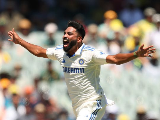 India's Mohammed Siraj (in white uniform) celebrates a moment in India's second Test against Travis Head and Australia in Adelaide over the weekend. Siraj gets hefty fine, Head reprimanded for heated spat in Adelaide