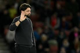 Coach Russell Martin, in black shirt, shrugs off boos from the fans in Southampton's match against Tottenham on Sunday. Martin sacked as Southampton coach after big loss