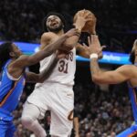 Cleveland center Jarrett Allen (31, middle) drives his way against 2 OKC defenders on Wednesday. Cavs outduel Thunder in marquee matchup