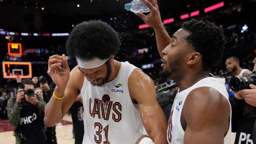 Jarrett Allen (31, left) gets doused with water from teammate Donovan Mitcell (right) after Cleveland faced OKC on Wednesday. Cavs outduel Thunder in marquee matchup