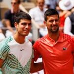 Carlos Alcaraz (left), and Novak Djokovic (right) pose for photographers after a match in file photo. Djokovic, Alcaraz in same side of Australian Open draw