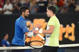 Serbia's Novak Djokovic (left), shakes hands with Portugal's Jaime Faria (right) after their Australian Open match on Wednesday. Djokovic adds new record