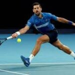 Serbia's Novak Djokovic returns a shot at the Australian Open on Tuesday. Djokovic, Alcaraz hurdle Australian Open tests