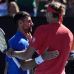 Serbia's Novak Djokovic (left) greets German Alexander Zverev (right) on center court after their semifinals match on Friday .Djokovic retires, booed in Australian Open semis