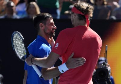 Serbia's Novak Djokovic (left) greets German Alexander Zverev (right) on center court after their semifinals match on Friday .Djokovic retires, booed in Australian Open semis