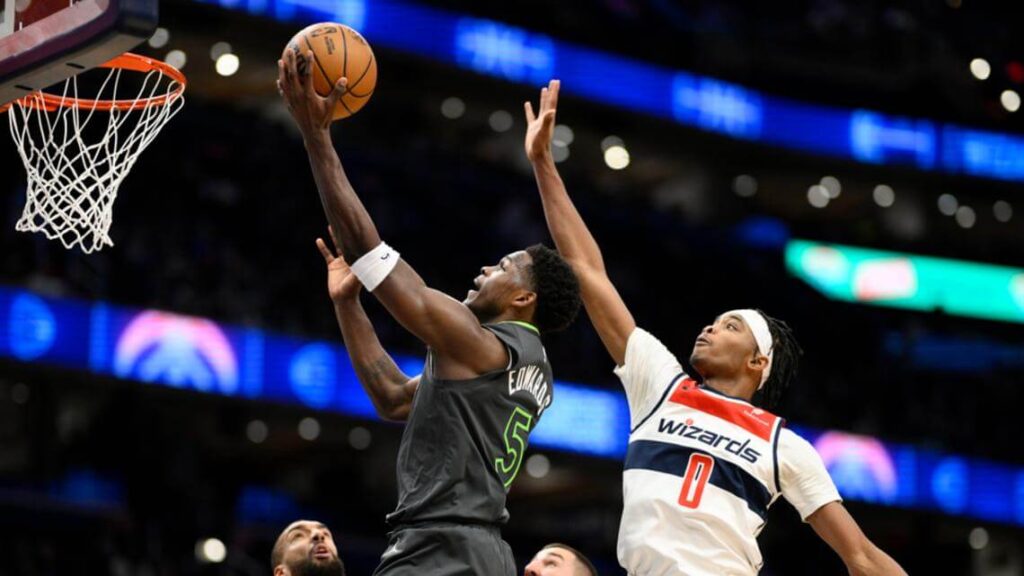 Minnesota guard Anthony Edwards (5, left) drives past a Washington defender for a layup in their game on Monday. Edwards fined USD50,000 for obscene gestures