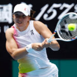 Poland's Iga Swiatek returns a shot at the Australian Open on Thursday. Swiatek, Raducanu set for Australian Open matchup