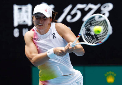 Poland's Iga Swiatek returns a shot at the Australian Open on Thursday. Swiatek, Raducanu set for Australian Open matchup