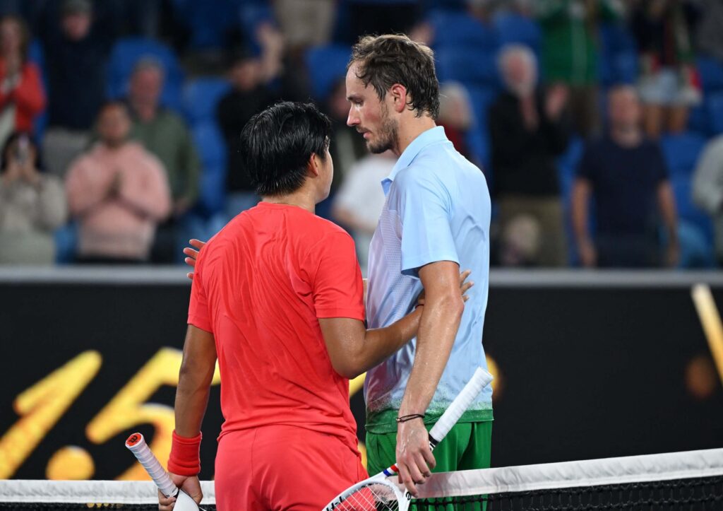 Russia's Danill Medvedev (right) meets American Learner Tien (left) at center court after their match on Thursday. Medvedev out, Sinner wins at Australian Open