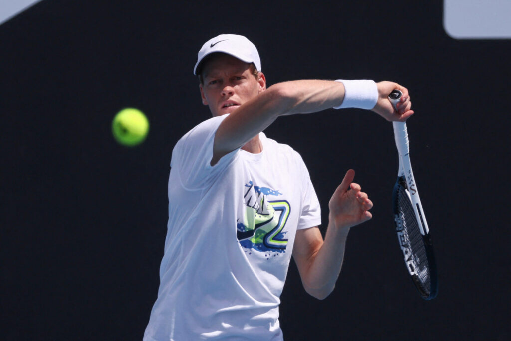 Italy's Jannik Sinner (middle) returns a shot in his Australian Open match against Nicolas Jarry on Monday. Sinner wins, Tsitsipas loses in Melbourne