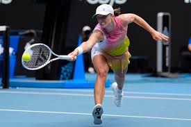 Poland's Iga Swiatek lunges to return a shot against Emma Navarro in their quarterfinals duel on Wednesday. Swiatek routs Navarro, advances to Australian Open semis vs Keys