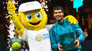 Spaniard Carlos Alcaraz poses with a mascot in his final match against Alex De Minaur of Australia in Rotterdam on Sunday. Alcaraz 'feeling better' after winning Rotterdam Open title