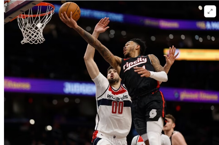 Portland's Anfernee Simmons (right) drives for a layup over Washington Tristan Vikcevic (left) in their game on Wednesday. Sharpe's vicious dunk caps 36-point night as Blazers drop Wizards