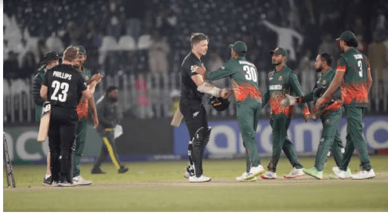 New Zealand players Glenn Philipps (second from left) and Michael Bracewell (center) shake hands with their Bangladeshi counterparts in their match on Monday. Players from England (in blue) nd Afhanistan (yellow) converge in the pitch during their match on Monday. Afghanistan vs England match set at Champions Trophy; NZ wins