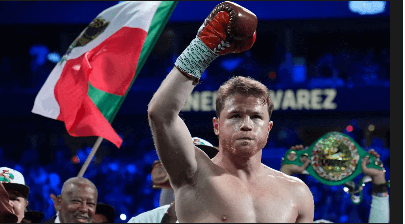 Canelo Alvarez raises his hands in triumph along with a Mexican flag in file photo. Canelo to fight in Riyadh in May under four-bout deal