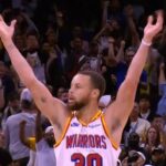 Golden State Warriors' guard Stephen Curry aises his hands in celebration after his amazing night ibn Orlando on Thursday. Curry drops 56 points, 12 3s in Warriors' win over Magic