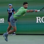 Serbia's Novak Djokovic returns a shot in his stint at the BNP Paribas Open in Indian Wells in2024. Djokovic in Indian Wells players' list despite torn hamstring injury