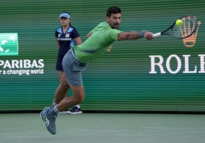 Serbia's Novak Djokovic returns a shot in his stint at the BNP Paribas Open in Indian Wells in2024. Djokovic in Indian Wells players' list despite torn hamstring injury