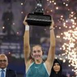 Russia's Mirra Andreeva raises her trophy after winning the Dubai Championships title on Saturday. Andreeva reaches WTA rankings top 10 as teener