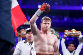 Mexican champion Canelo Alvarez (right) raises his right hand to acknowledge cheers from the crowd in a past fight in file photo. Paul slams Canelo in fiery video; Alvarez to face Scull in May