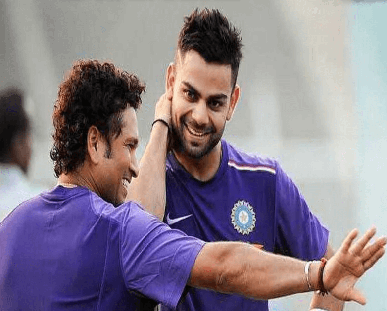 Sachin Tendulkar (lerft) gives instructions to Virat Kohli (right) in the field in file photo. Gavaskar won't compare Kohli, Tendulkar due to 'different eras'