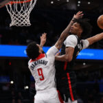 Portland's Shaedon Sharpe (right) soars for a dunk over Washington forward Justin Champagnie (right) in their game on Wednesday. Sharpe's vicious dunk caps 36-point night as Blazers drop Wizards