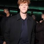 Italy's Jannik Sinner poses for photographers at the Milan Fashion Show for Gucci on Tuesday. Sinner makes appearance at Gucci show for first time since ban