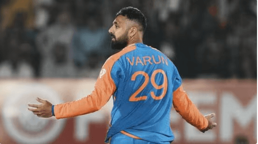 Varun Chakravarthy raises his arms at an India match in file photo. Varun to join India's ODI squad against England after T20I exploits