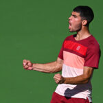 Spain's Carlos Alcaraz pumps his fists to celebrate a point at a match in Indian Wells in file photo. Alcaraz cruises through Indian Wells' final 16