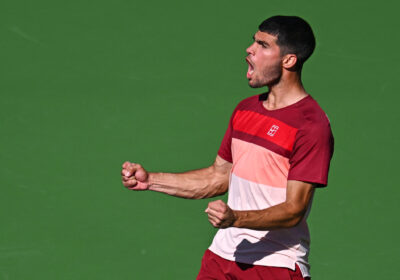 Spain's Carlos Alcaraz pumps his fists to celebrate a point at a match in Indian Wells in file photo. Alcaraz cruises through Indian Wells' final 16