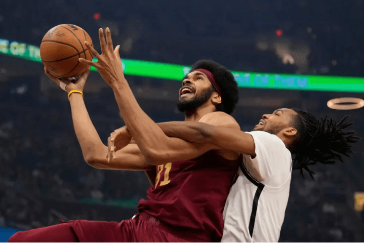 Cleveland center Jarrett Allen (31, left( attempts a drive but was fouled by Brooklyn's Ziaire Williams (right)  in their game in Cleveland on Tuesday. Cavaliers vs Nets game gets Cleveland second 15-game win streak