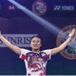 South Korea's An Se-young raises her arms in celebration during her final match on Saturday. An cops Orleans Masters 2025 title