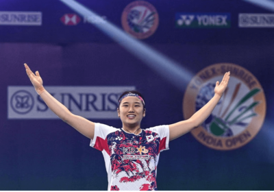 South Korea's An Se-young raises her arms in celebration during her final match on Saturday. An cops Orleans Masters 2025 title