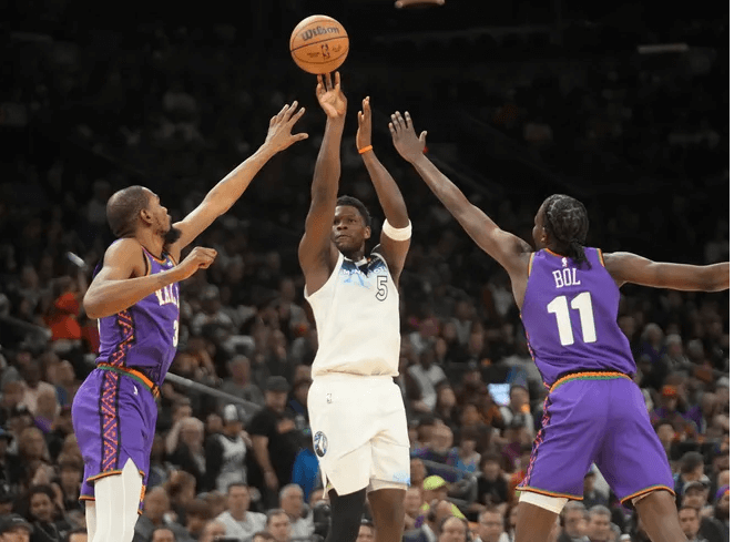 Minnesota TImberwolves guard Anhony Edwards (5, middle) shoots over Phoenix Suns forward Kevin Durant (35, left) center Bol Bol (right) in their game on Sunday. Durant slams Suns, felt 'embarrassed' after stinging loss to Wolves