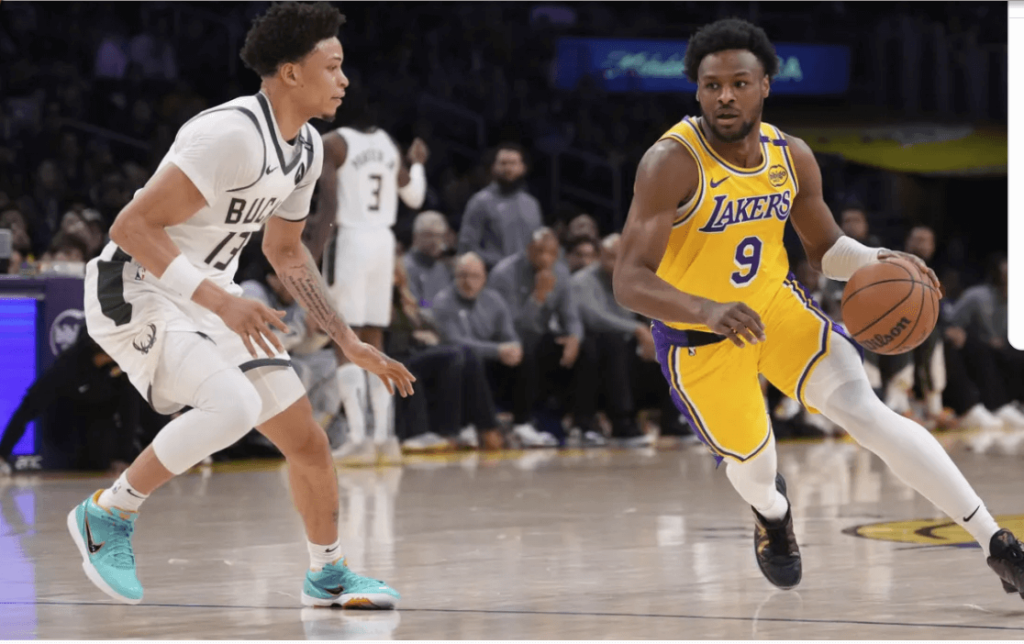 Los Angeles Lakers guard Bronny James (brown drives against Milwaukee's Ryan Rollins in their game vs Milwaukee on Thursday. Bronny James gets lone bright spot in Lakers' loss to Bucks