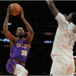 Phoenix Suns forward Kevin Durant (35, left) drives against Minnesota Timberwolves center Naz Reid (right) in their game on Sunday. Durant slams Suns, felt 'embarrassed' after stinging loss to Wolves