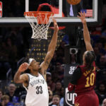 Cleveland guard Darius Garland (10, right) drives for a layup againdt Brooklyn big man Nic Claxton (33, left) in their game in Cleveland on Tuesday. Cavaliers vs Nets game gets Cleveland second 15-game win streak