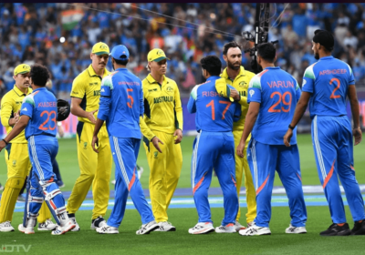 Players from Australia (in yellow) and India (in blue) shake hands after their Champions Tropphy 2025 match in Dubai pmn Tuesday. India reaches Champions Trophy 2025 final after beating Australia