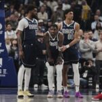 Dallas guard Kyrie Ierving (middle, 11) is being assisted by teammates after he had a torn ACL on his left knee on Monday. Irving injury rules him out