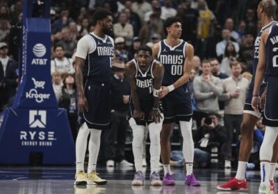 Dallas guard Kyrie Ierving (middle, 11) is being assisted by teammates after he had a torn ACL on his left knee on Monday. Irving injury rules him out