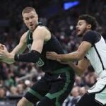 Boston forward Kristaps Porzingis (left) posdts up against a Brooklyn defender in their game on Tuesday. The Celtics vs Nets game on Tuesday saw Boston still winning despite resting top stars Jayson Tatum and Jaylen Brown.