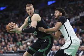 Boston forward Kristaps Porzingis (left) posdts up against a Brooklyn defender in their game on Tuesday. The Celtics vs Nets game on Tuesday saw Boston still winning despite resting top stars Jayson Tatum and Jaylen Brown.