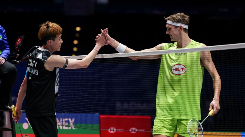 Denmark's Viktor Axelsen (right) shakes hands with Chinese Taipei's Lin Chun-yi (right) in their match Birmingham on Wednesday. Axelsen ousted in All England Open