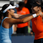 Britain's Emma Raducanu (left) and the US' Amanda Anisimova (right) hug at center court in Miami after their martch on Monday. Raducanu stops Anisimova in Miami Open