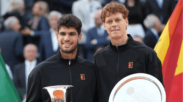 Spain's Carlos Alcaraz (left) and Italian Jannik Sinner (right) pose with their trophies after their Italian Open men's singles final on Sunday.