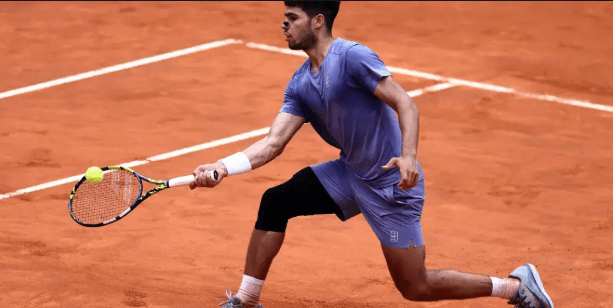 Spain's Carlos Alcaraz stretches for a shot in his Italian Open 2025 match against Kharen Khachanov on Tuesday. Alcaraz tops Khachanov at Italian Open; Sinner, Paolini advance