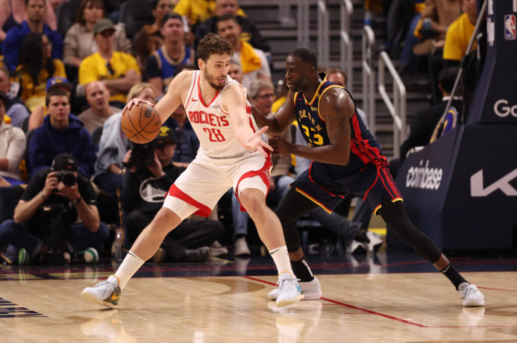 Houston center Alperen Sengun (28, left) posts up against Golden State forward Draymond Green (23, right) in Game 7 of their first round serives in Houston on Sunday. Rockets vs Warriors sees Hield lead Dubs to Game 7 win